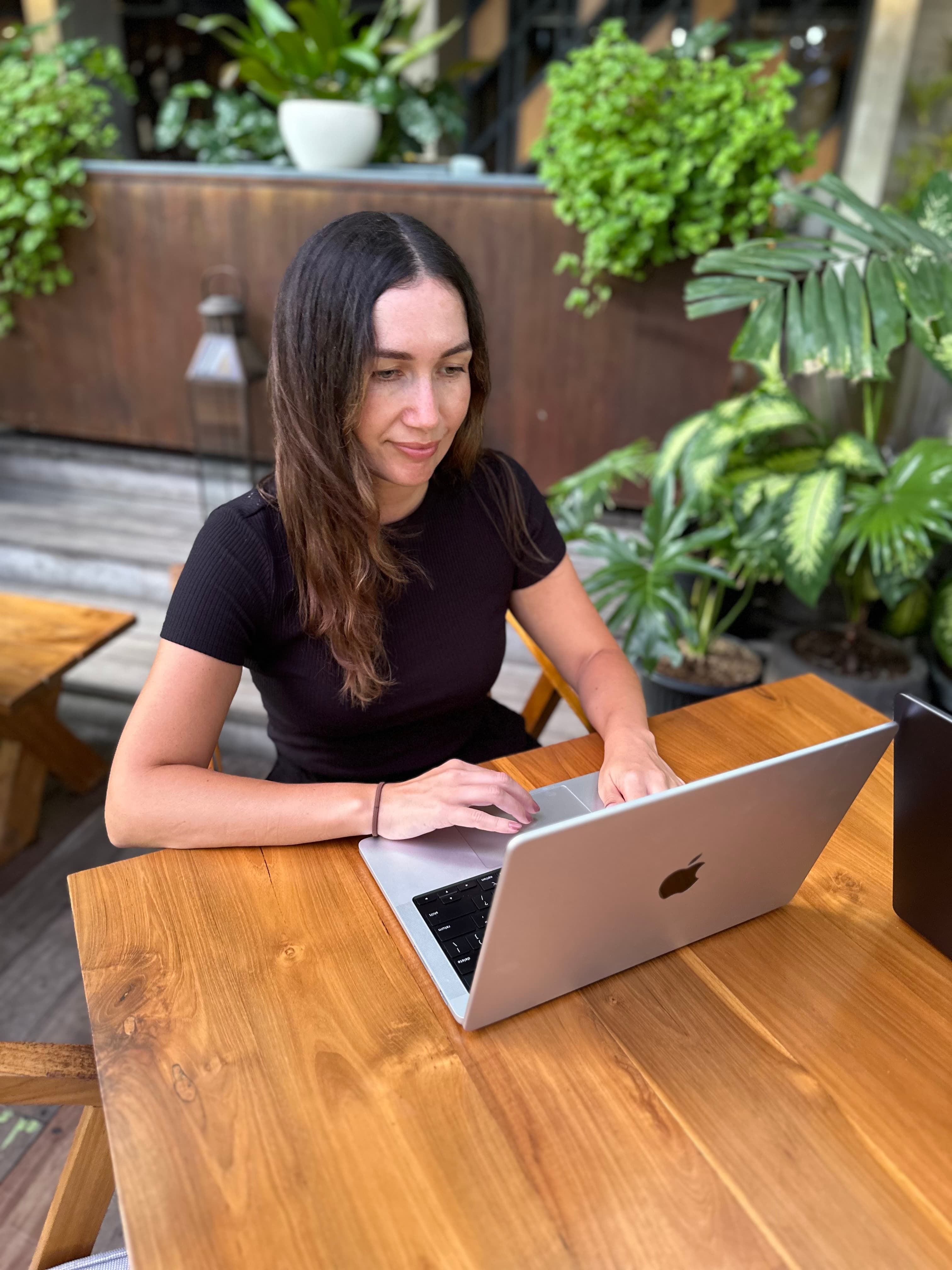Jayne Hamilton working on a laptop at an outdoor table